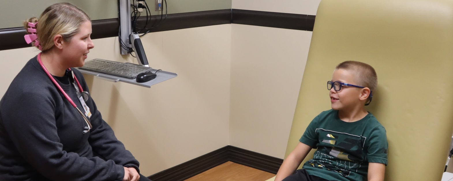 Caitlyn and patient in exam room